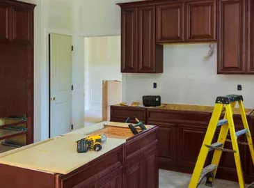 Kitchen under renovation with new cabinets and construction tools