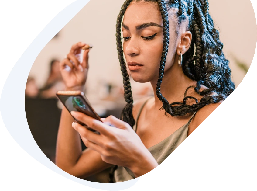 Woman holding her phone as she applies for a $1,500 loan to cover a short-term cash gap