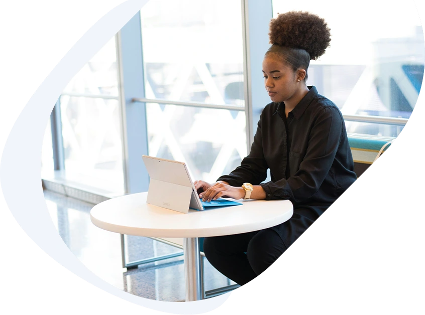 Focused woman checking her laptop, waiting for a fast approval $8,000 loan to be deposited into her account