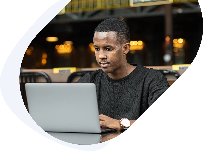 Young man applying for a fast loan on his laptop with no phone calls required