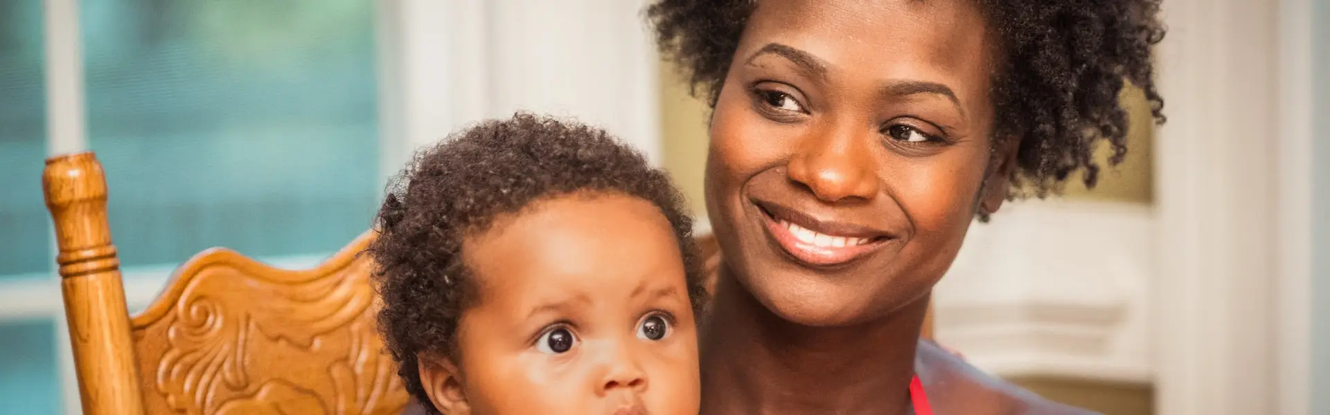 Single mother spending time with her child while managing emergency cash needs
