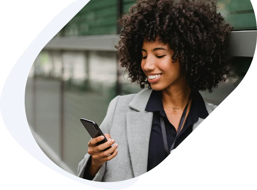 Smiling woman applying for a payday loan for bad credit using her phone