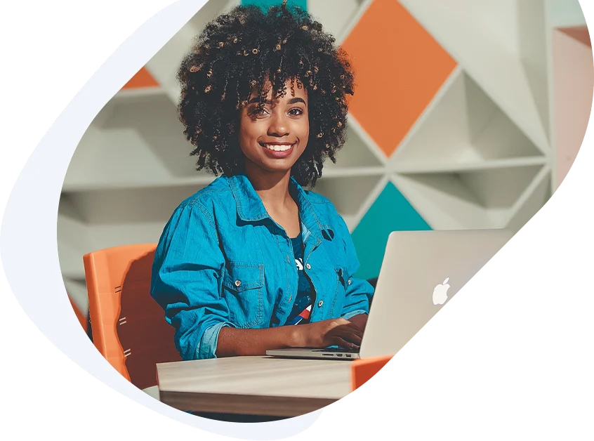 Confident young woman using her laptop to apply for a guaranteed payday loan